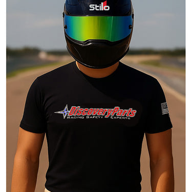 Person wearing a black t-shirt with Discovery Parts logo and a Stilo helmet on a road racing background